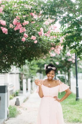 Jocelyn standing under some trees and flowers in Charleston, SC