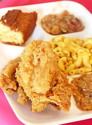 A dinner plate from Martha Lou’s that includes fried chicken, mac and cheese and beans in Charleston