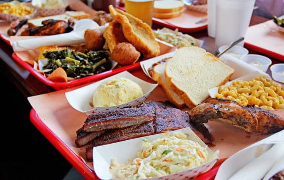 Soul food classics at Rodney Scott's including greens, fried fish, hush puppies, ribs, baked beans and mac and cheese