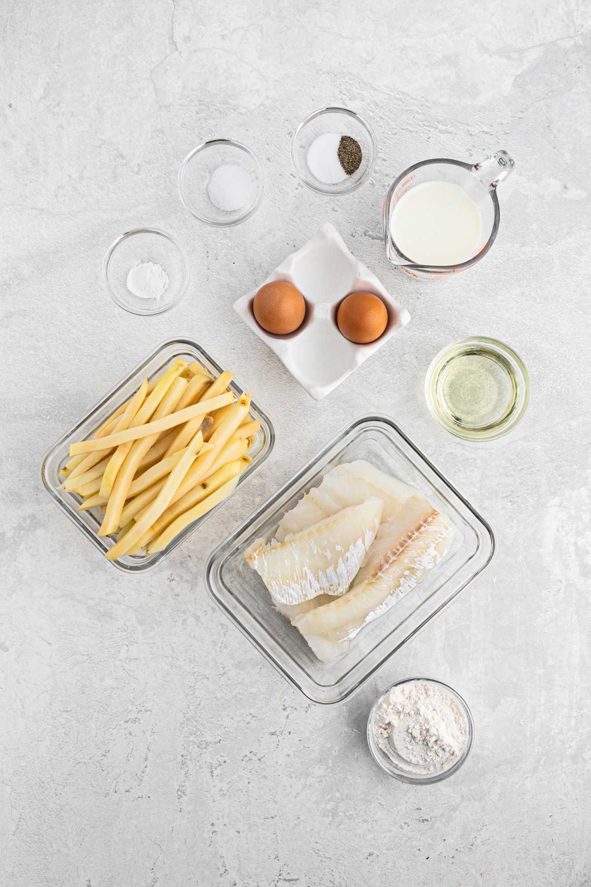 Ingredients to make fish and chips on the table.