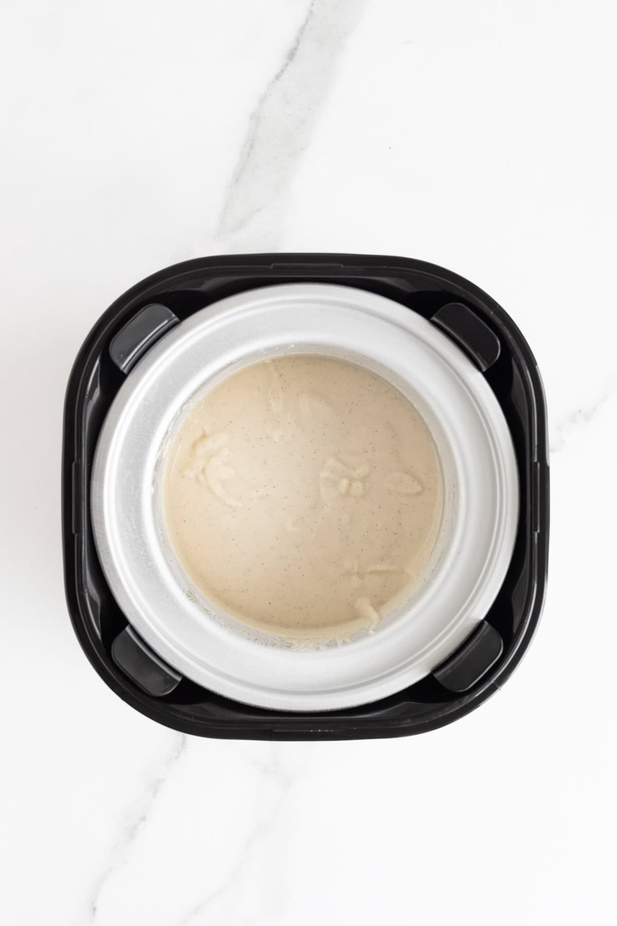 Custard poured into the bowl of an ice cream maker