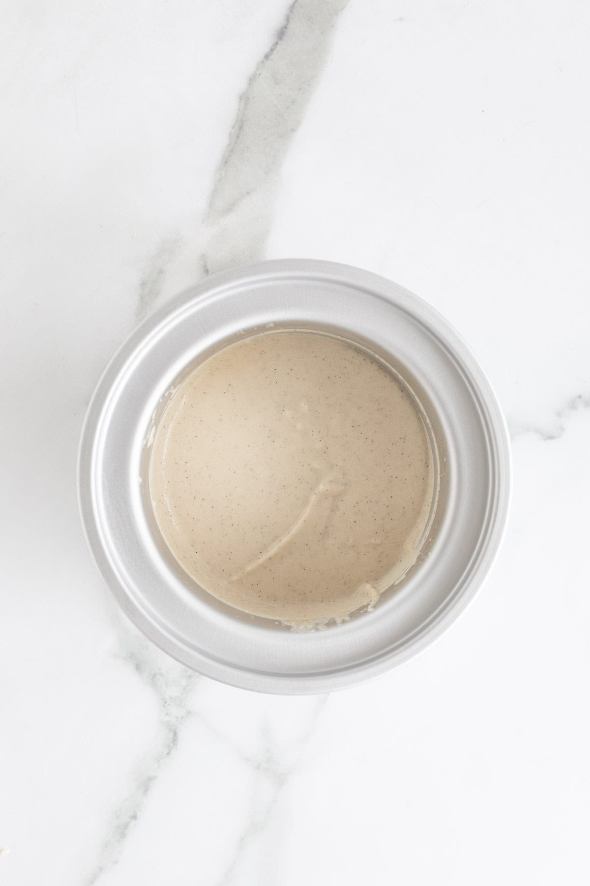 Partially churned vanilla ice cream inside the ice cream machine