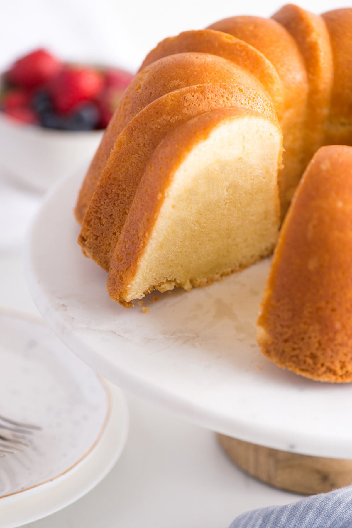 Sour cream pound cake with slices cut.
