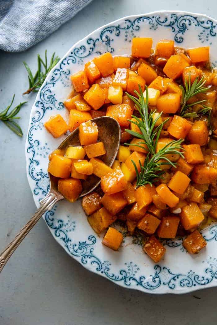 Mango Roasted Butternut Squash Recipe close up overhead on blue plate with big spoon to serve