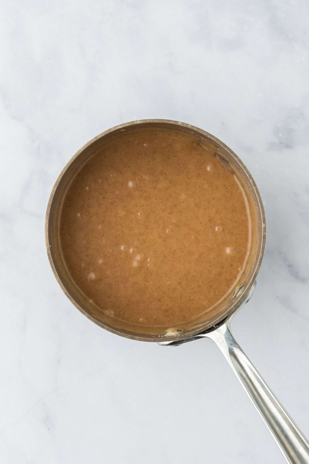 Finished brown butter glaze in a saucepan on white countertop