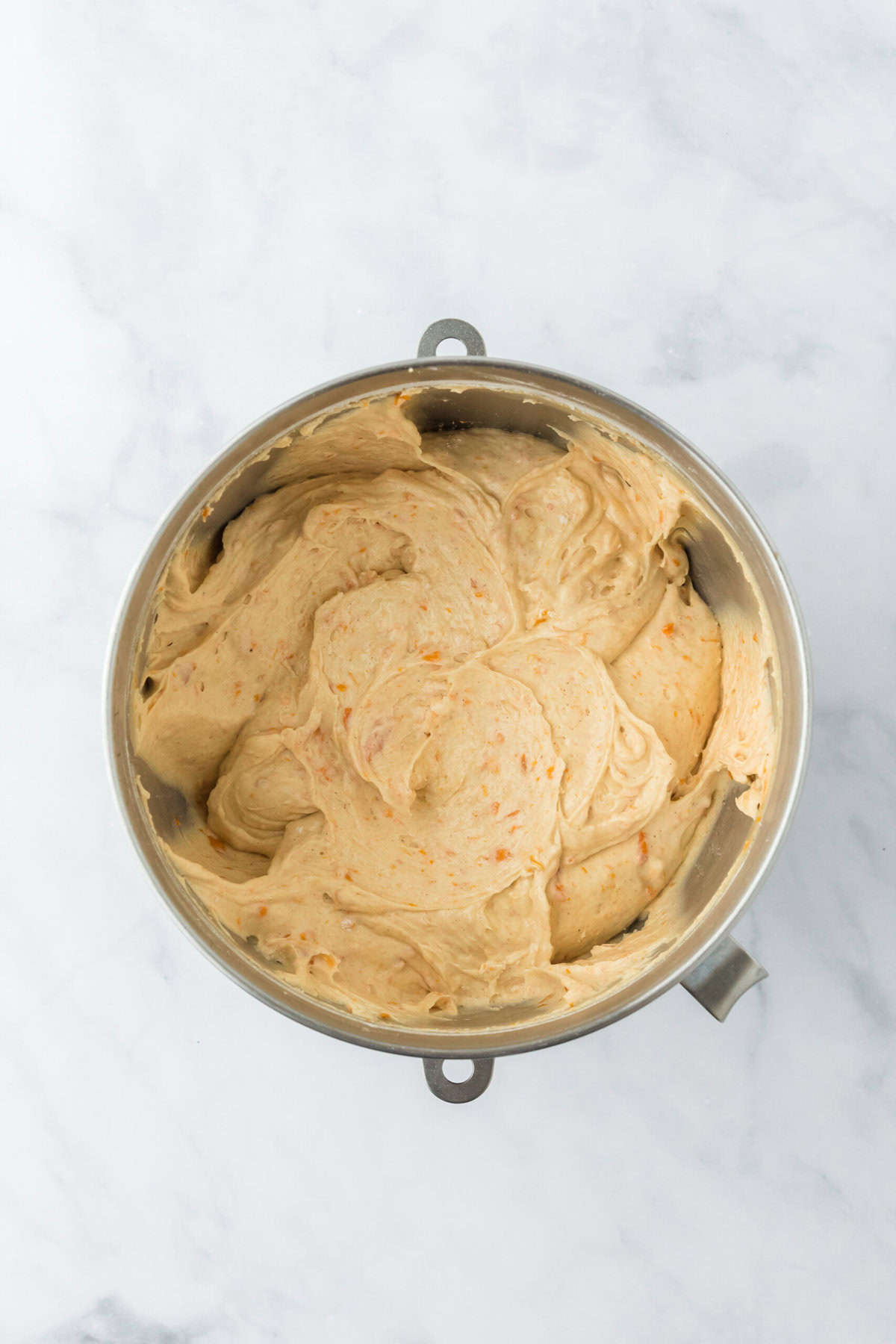 Finished sweet potato batter in stand mixing bowl on white countertop