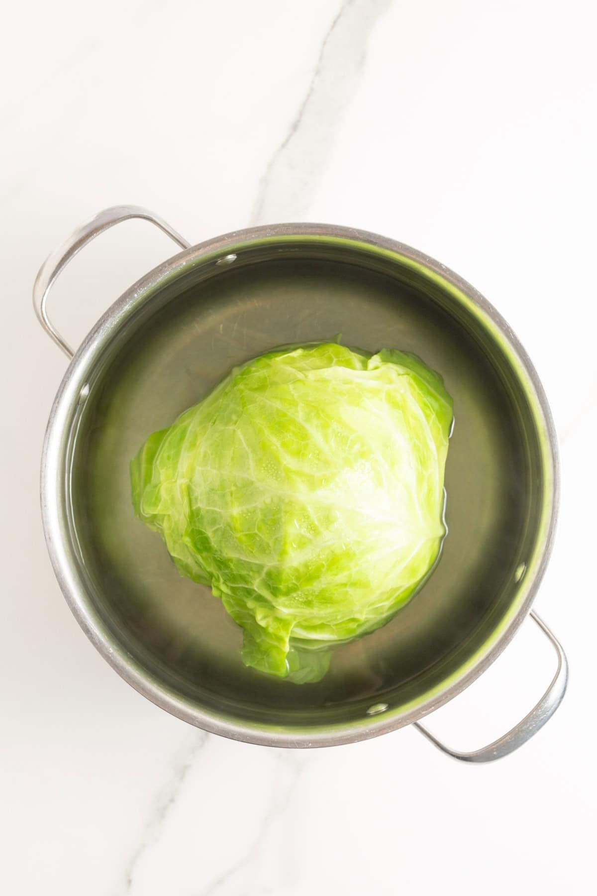 Cabbage added to a pot filled with water