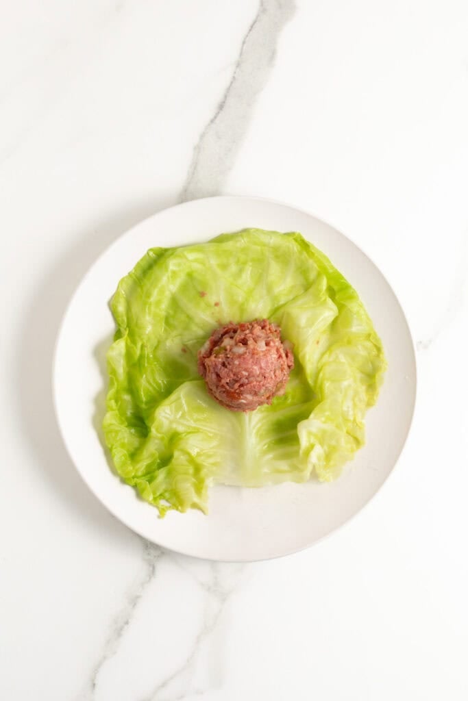 Meat mixture added to center of a cabbage leaf