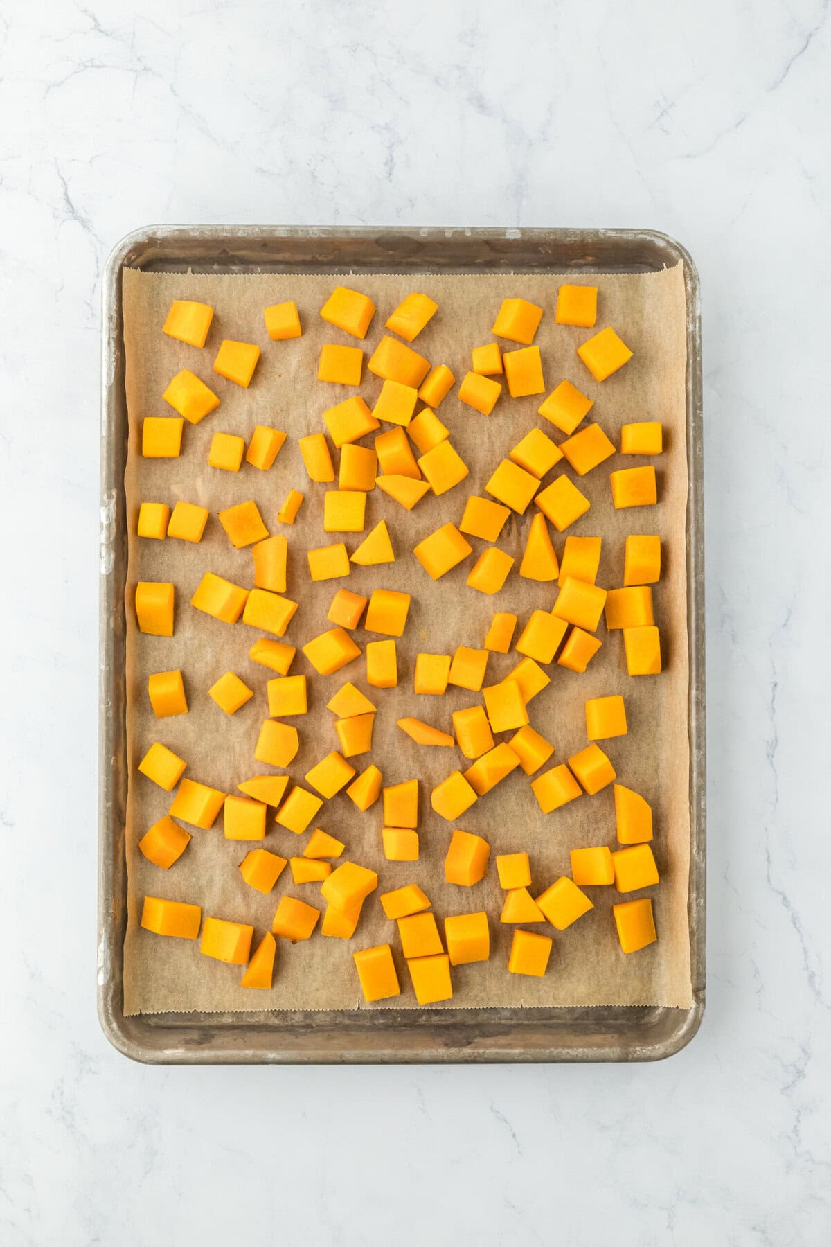 Baked roasted butternut squash on a baking sheet out of the oven