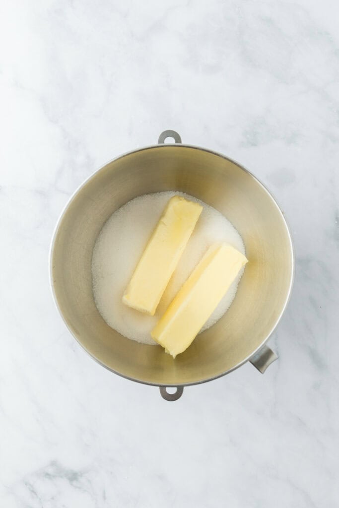 Butter and sugar in a mixing bowl to cream together