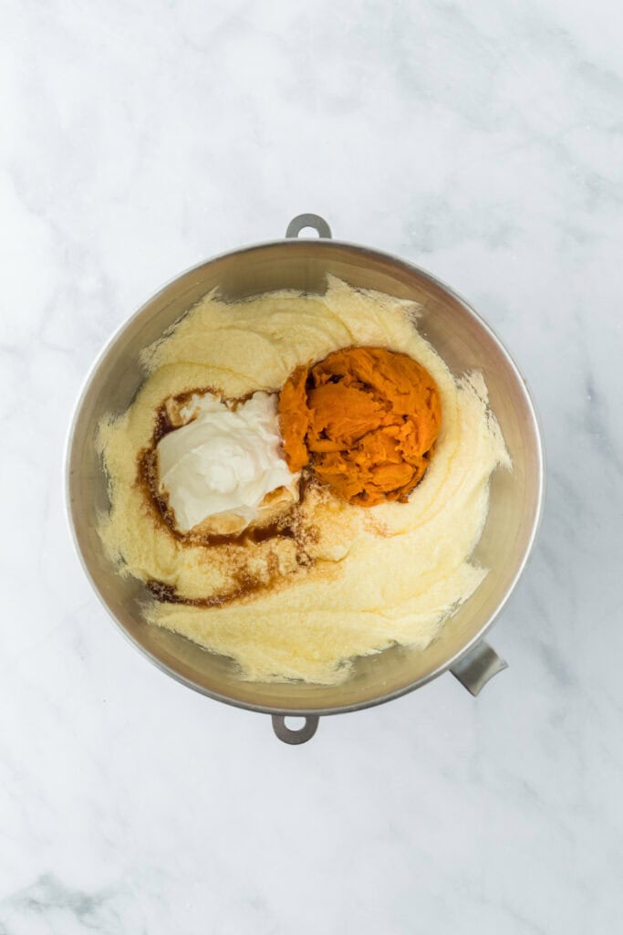 Sweet potato and sour cream being added to cake batter