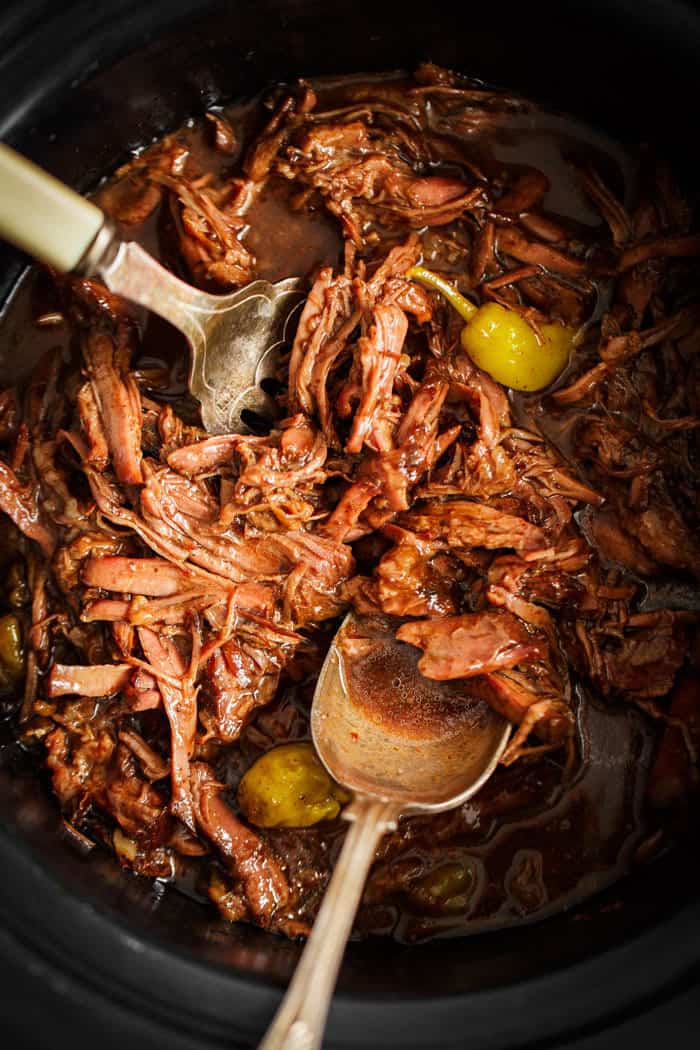 A look down at the crockpot with shredded slow cooker pot roast ready to serve