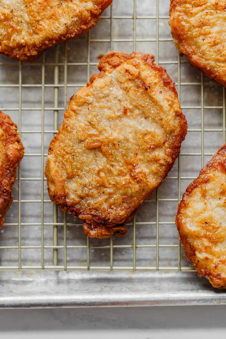 4 Fried Pork Chops draining on rack