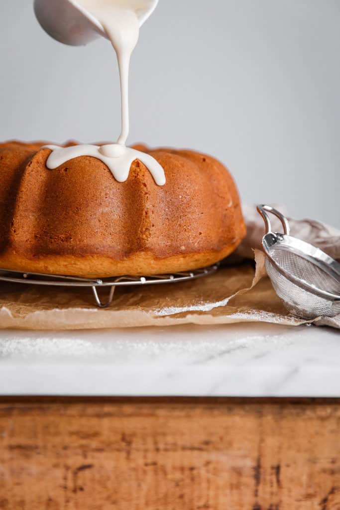 Maple glaze being poured over sweet potato cake