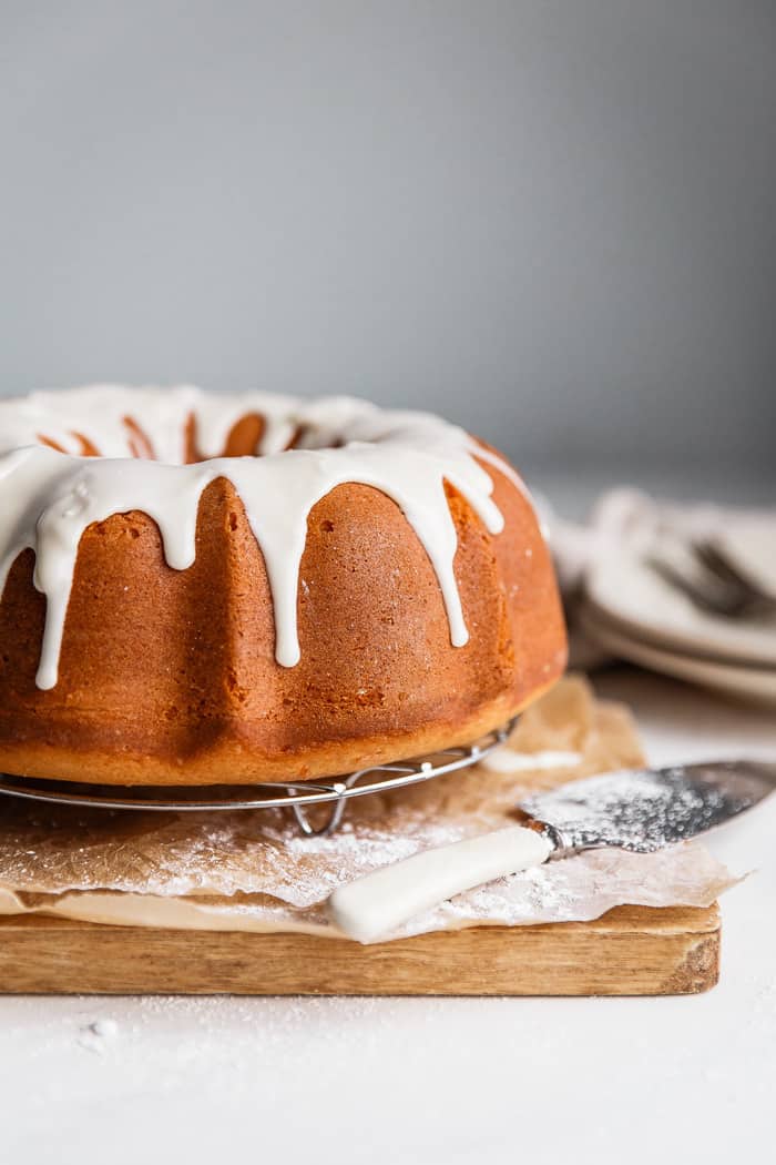 A whole Sour Cream Coffee Cake flavored with sweet potato topped with maple glaze against white background