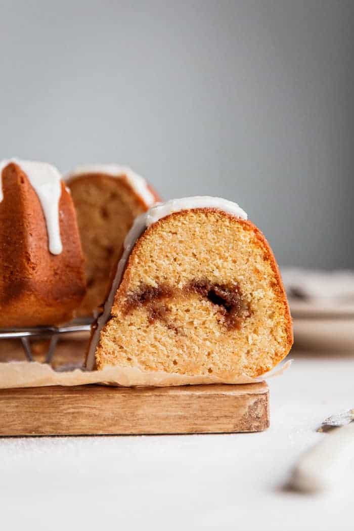 A slice of Sweet Potato Coffee Cake recipe with cinnamon swirl in center of photo in white background