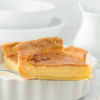 A slice of the best buttermilk pie lifted on a server