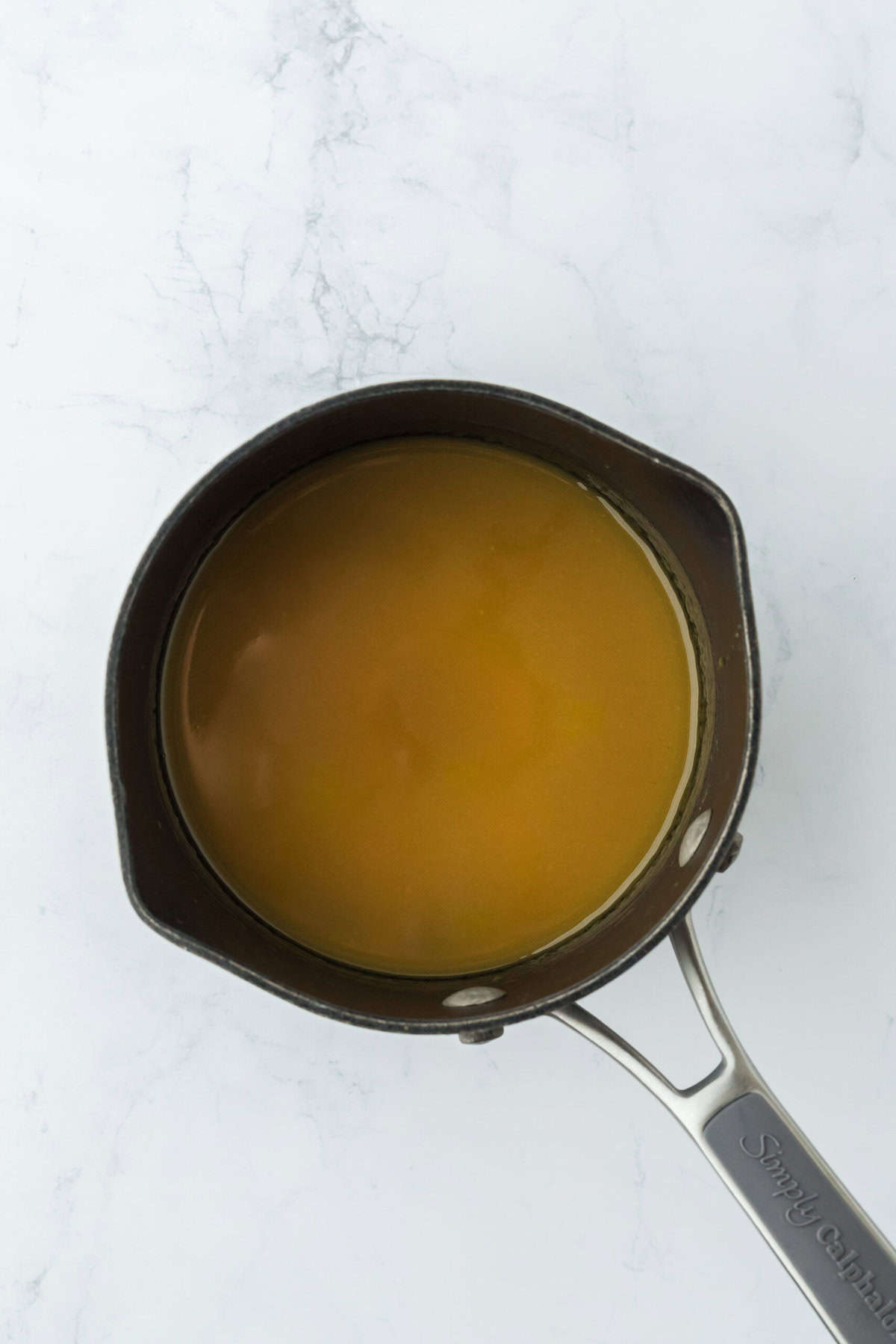 Eggnog maple syrup ready in a saucepan to pour over pancakes