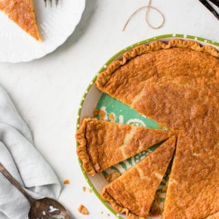 Overhead of Vanilla Buttermilk pie on green pie plate with slice on white dessert plate