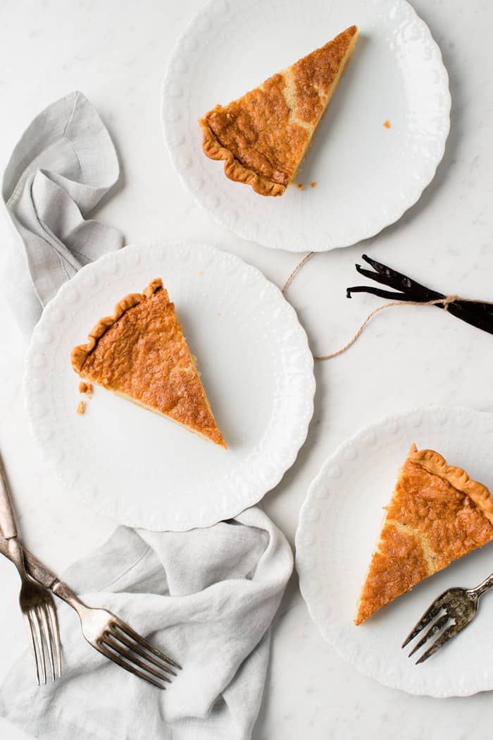 Overhead of buttermilk pie on three white plates