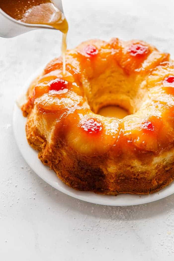 Pineapple Rum Cake getting soaked in pineapple butter rum sauce