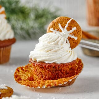 Perfect Gingerbread Cupcakes scattered against a white background with delicious buttercream piped high on each one