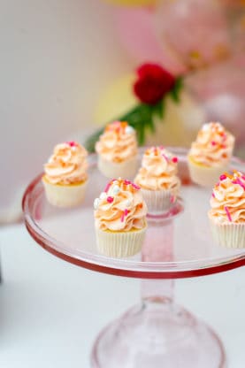 Glass cake plate used to display Hawaiian themed cupcakes