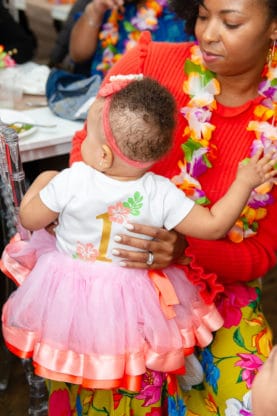 Jocelyn holding Harmony who is wearing her birthday Hawaiian t-shirt