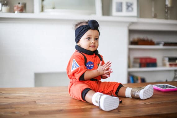 Harmony sitting on a table wearing her NASA astronaut's outfit