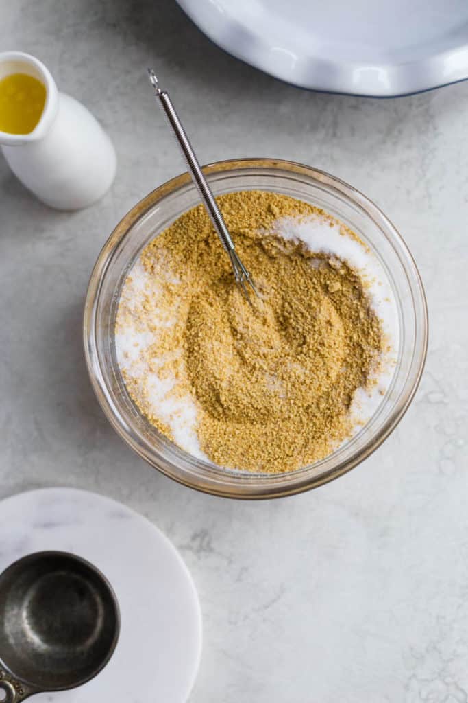 Stirring together ingredients for how to make graham cracker crust