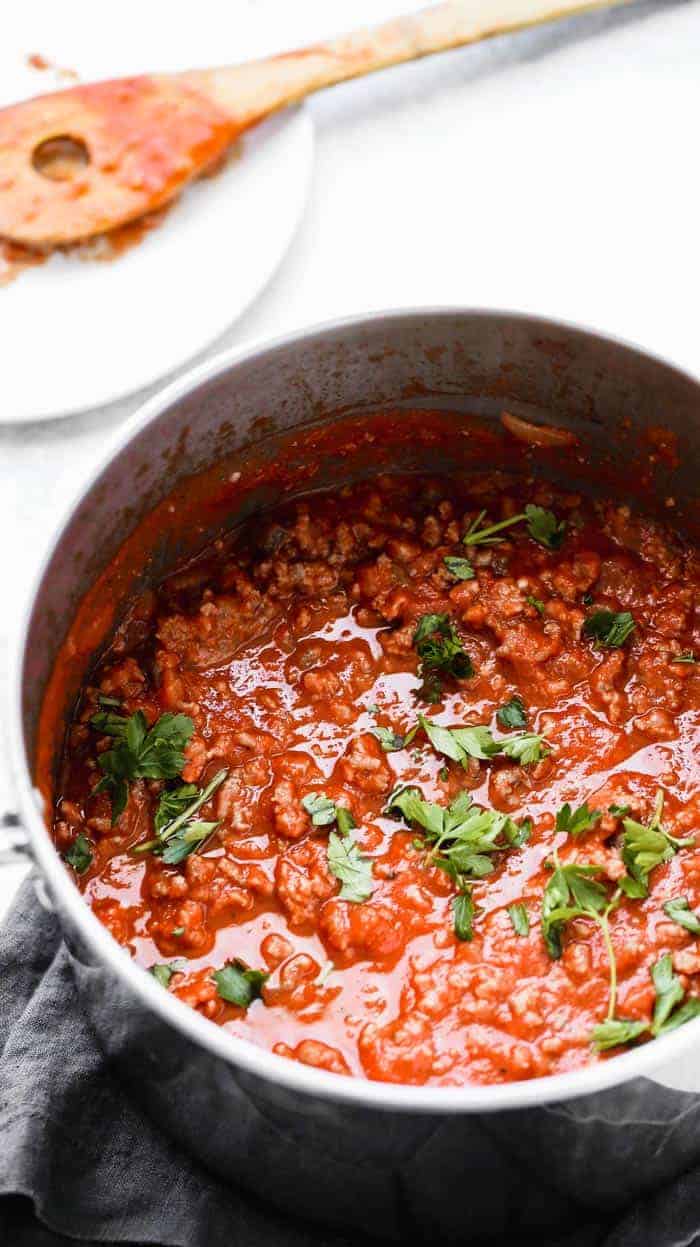 Big pot of homemade spaghetti sauce recipe against white background