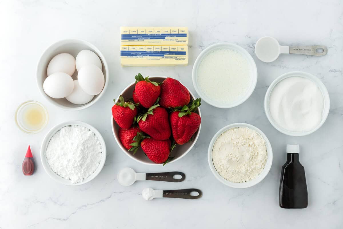 Bowls of strawberries, butter, flour and eggs to make a strawberry bundt cake recipe