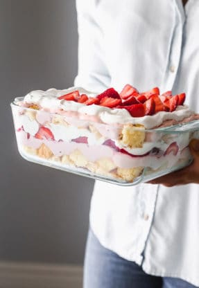 Strawberry Punch Bowl Cake being carried in arms