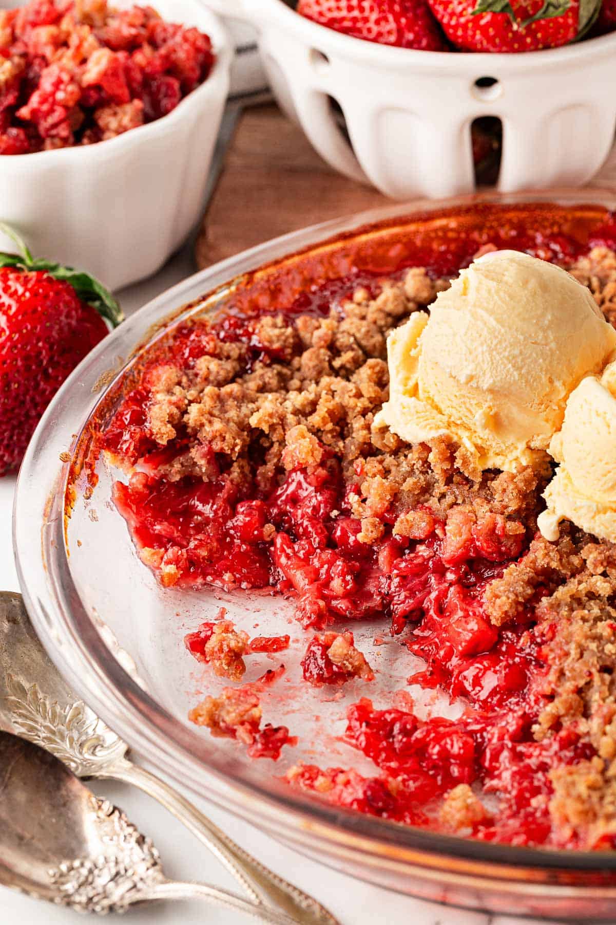 Strawberry crumble topped with a scoop of vanilla ice cream