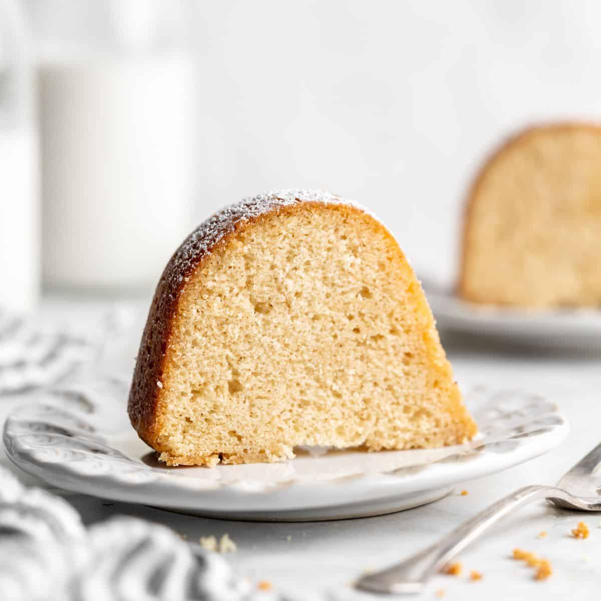 Close up of two slices of Kentucky Butter Cake on white plates
