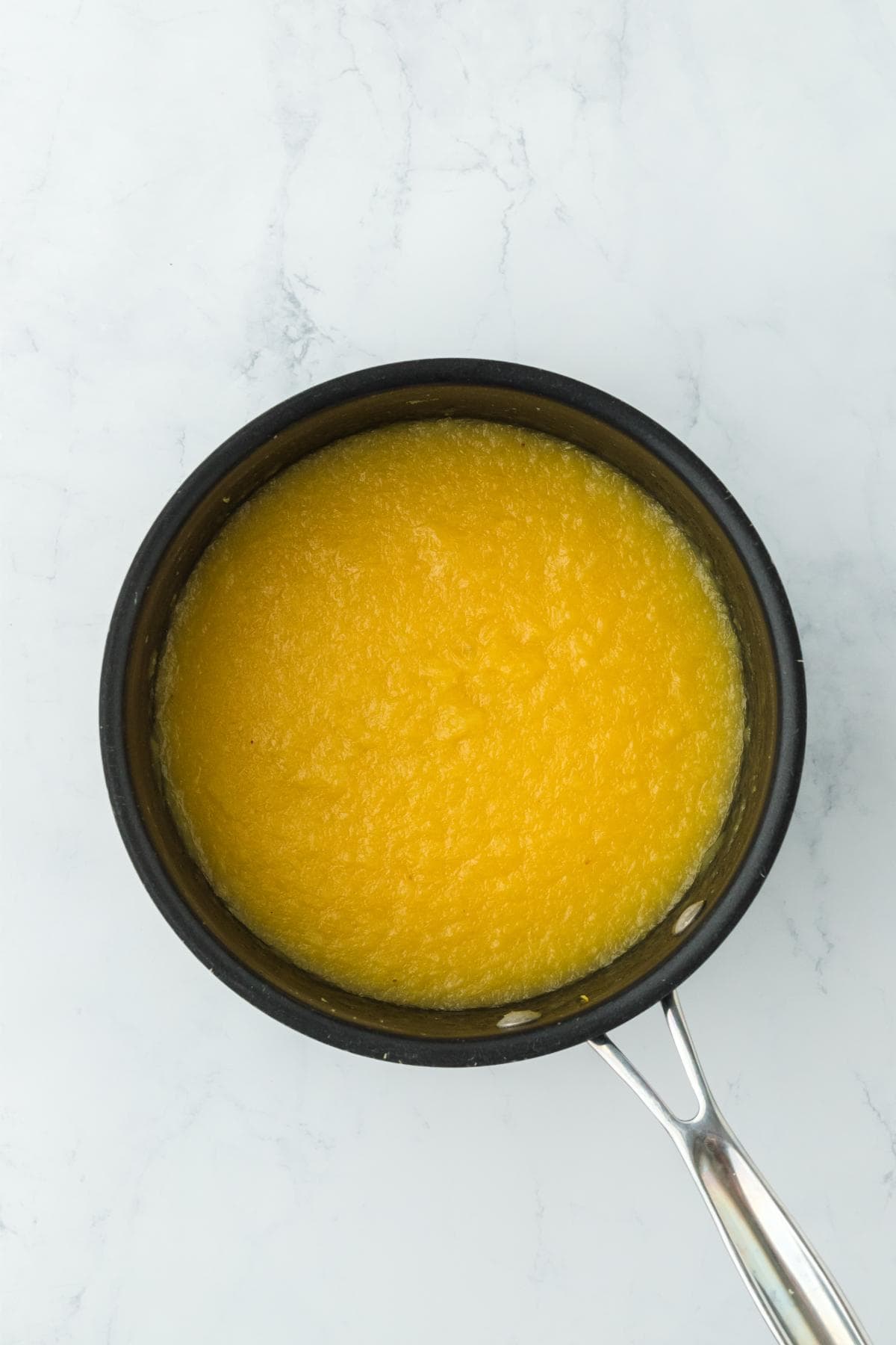 A thickened pineapple filling in a saucepan