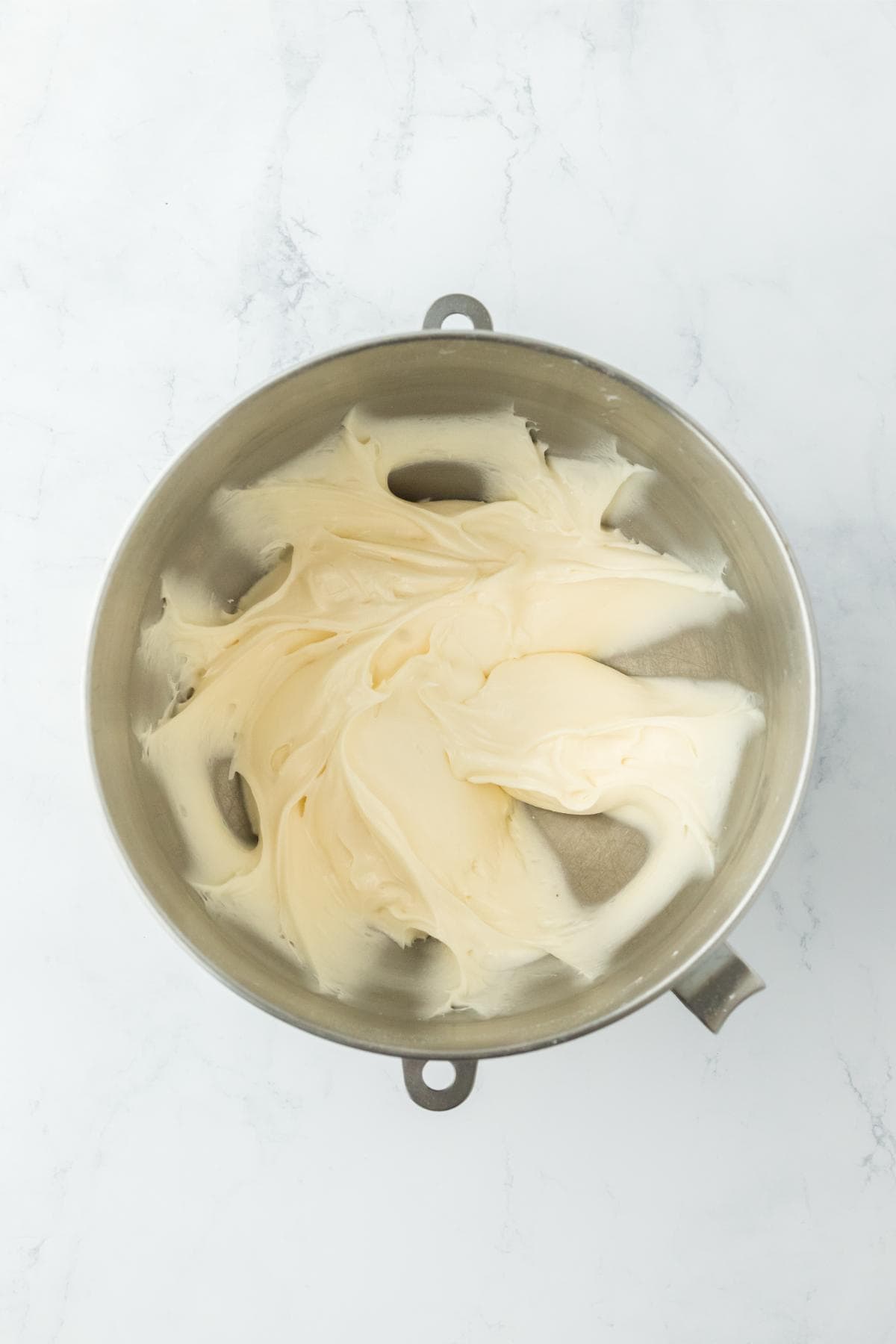 Finished smooth cream cheese frosting in the mixing bowl