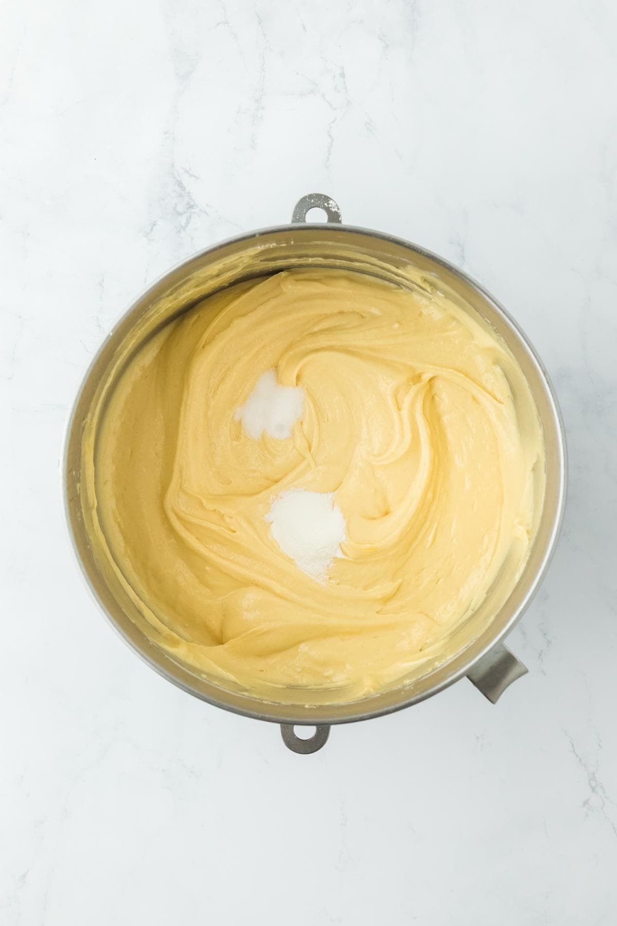 Smooth cake batter with salt and leavening agents added in a mixing bowl