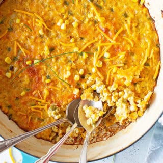 Delicious overhead of corn pudding being dug into with spoons