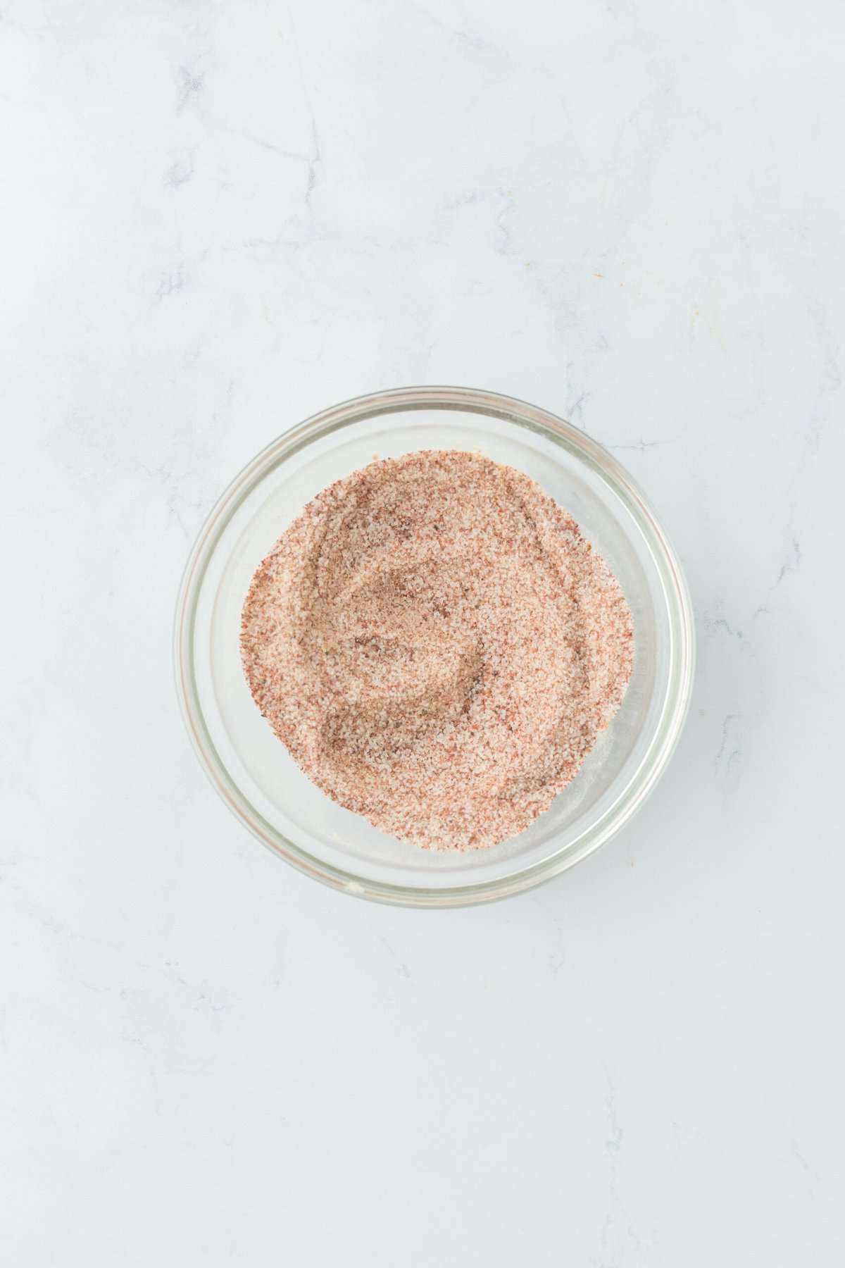 Shrimp spice blend in a glass bowl on white countertop