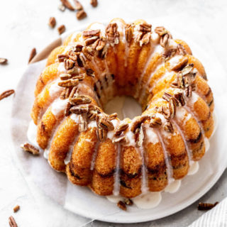 Overhead of Sock It To Me Cake on white plate with pecans