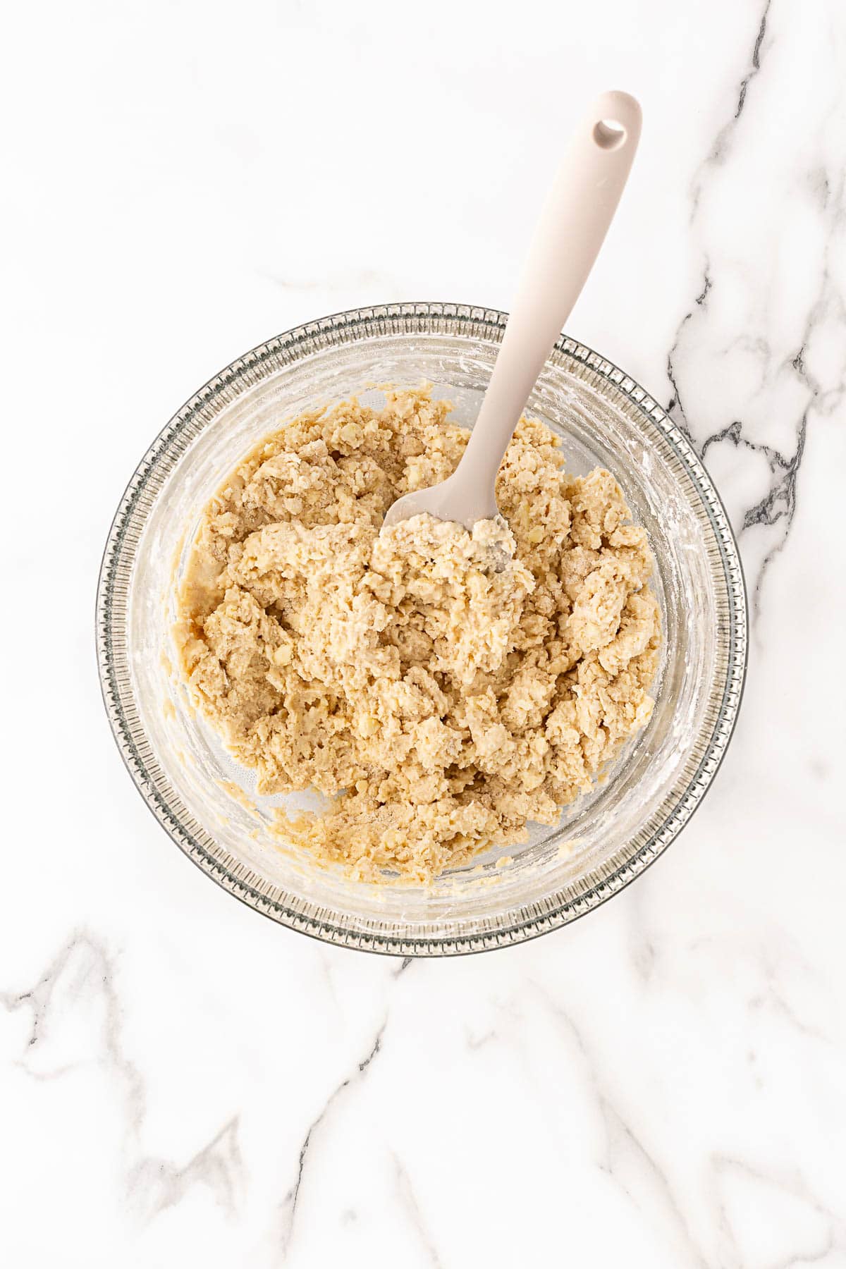 Biscuit cobbler topping dough mixed in bowl with spatula