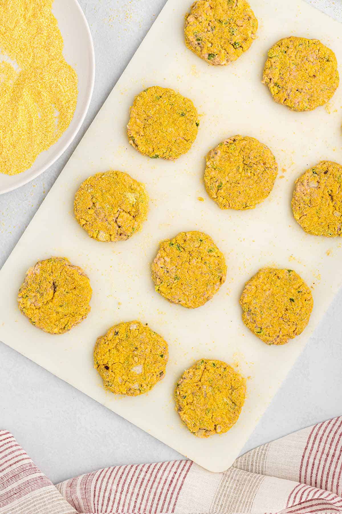 Salmon patties are coated with cornmeal breading.