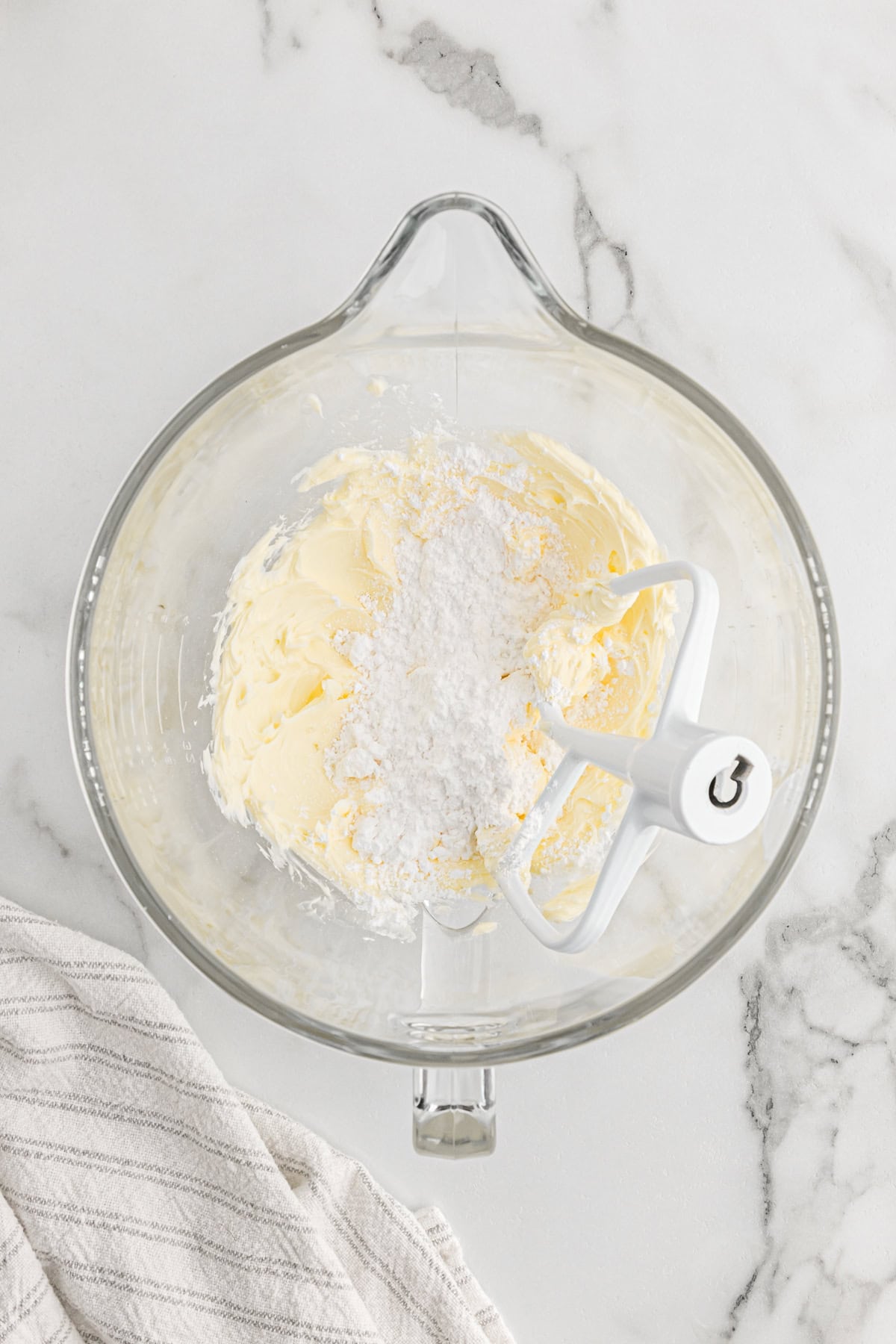 Confectioner's sugar and butter in stand mixer