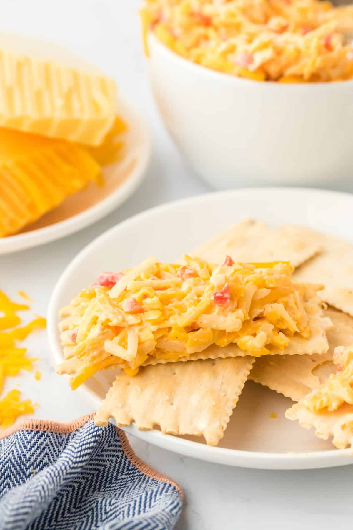 Pimento cheese spread on crackers before eating