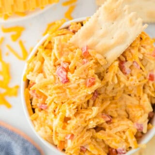 A cracker inside Southern pimento cheese recipe with cheese in the white background