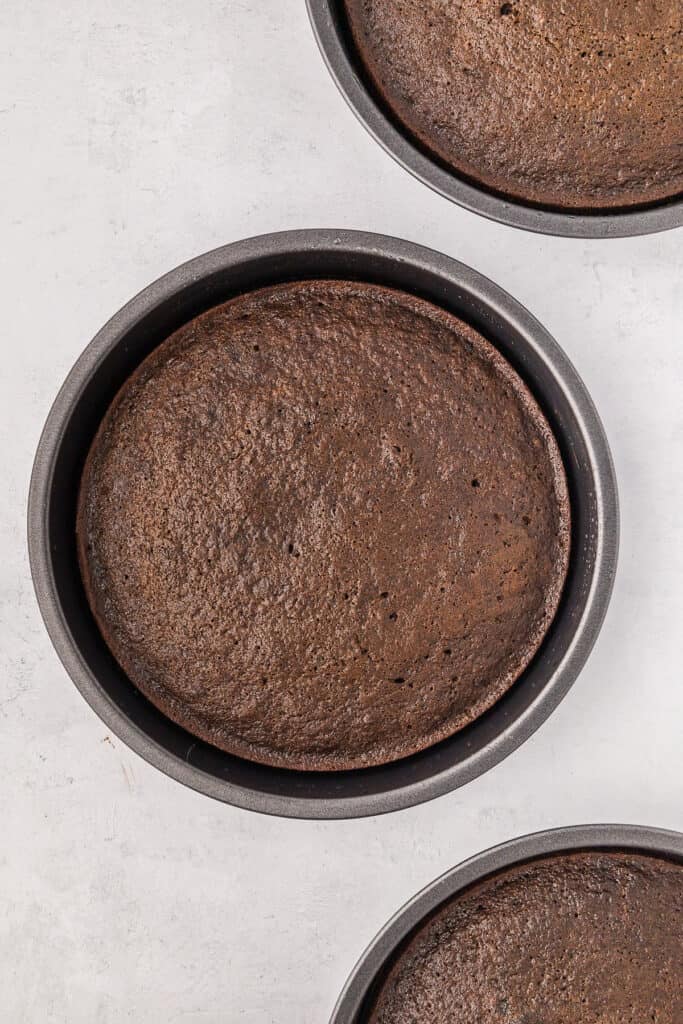Baked chocolate cake layers in pans out of the oven