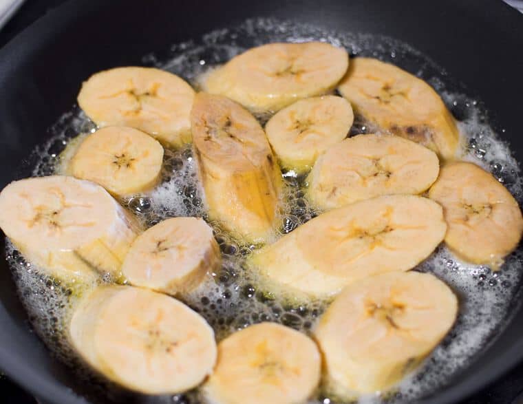 Sweet plantains frying in butter in a skillet