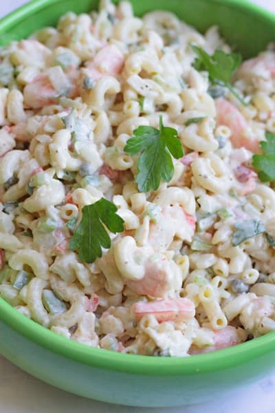 Close up of Seafood Macaroni Salad served in a green bowl for Labor Day recipes