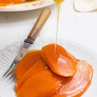 Candied Yams glaze being poured over a plate of Southern Candied Sweet Potatoes
